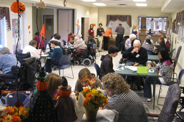 Students visiting a senior's residence on Halloween Intergenerational volunteers at a Halloween event