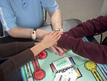 Students and a senior join hands Intergenerational volunteers joining hands