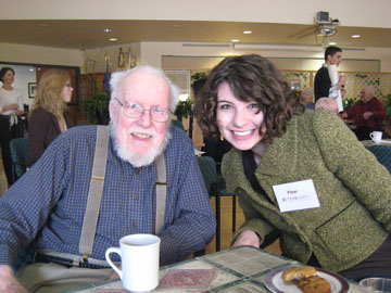 A LINKages volunteer visiting with her senior friend Student and senior intergenerational program participants